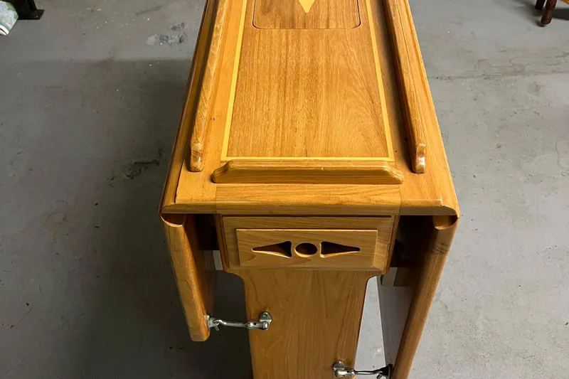 Spirit Yacht Photos Pics Wooden table with intricate design, part of a 2001 Cabo Rico Northeast 400.