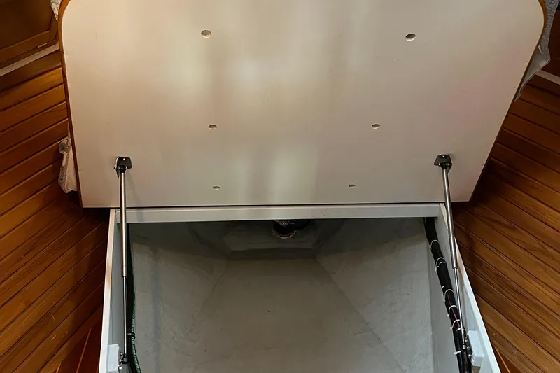 Spirit Yacht Photos Pics Open storage compartment on 2001 Cabo Rico Northeast 400 boat with wooden flooring.