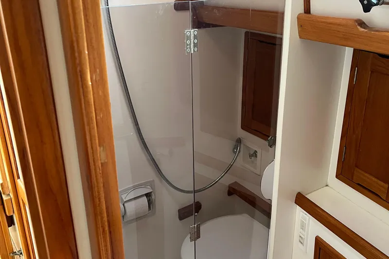 Spirit Yacht Photos Pics Bathroom interior of 2001 Cabo Rico Northeast 400 yacht with wooden cabinetry.