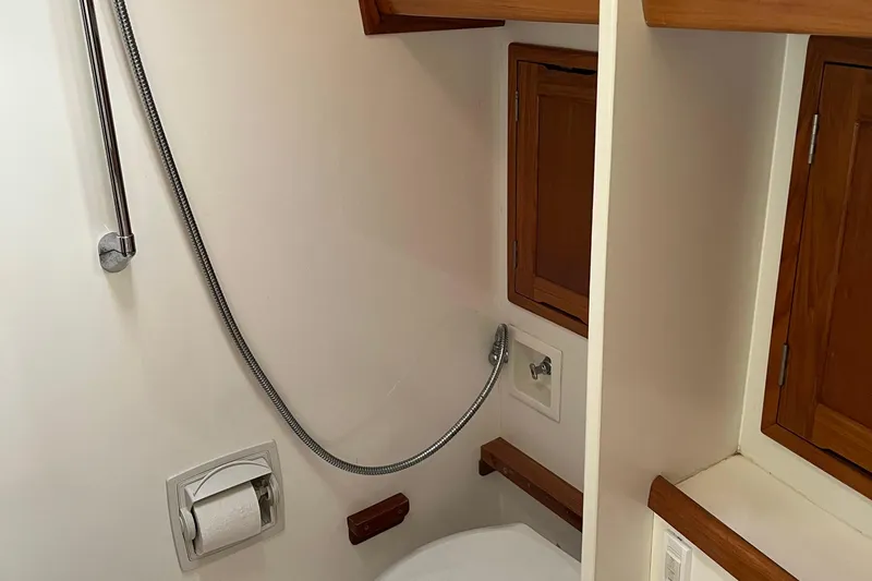 Spirit Yacht Photos Pics Bathroom interior of 2001 Cabo Rico Northeast 400 yacht with wooden cabinets.