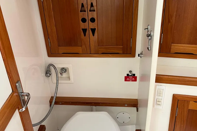 Spirit Yacht Photos Pics 2001 Cabo Rico Northeast 400 yacht bathroom with wooden cabinets and modern fixtures.