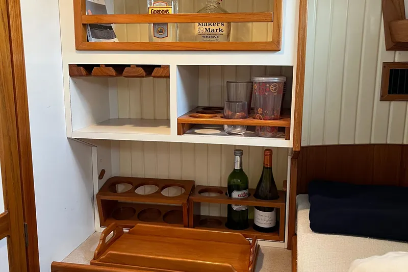 Spirit Yacht Photos Pics Cabinet with bottles and glasses in 2001 Cabo Rico Northeast 400 yacht interior.
