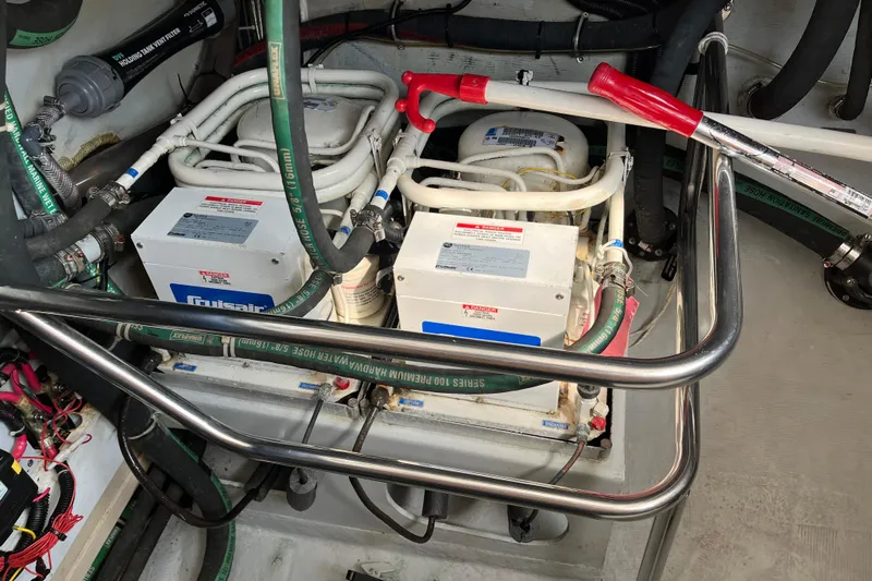 Spirit Yacht Photos Pics Engine room of 2001 Cabo Rico Northeast 400 with mechanical components and hoses.