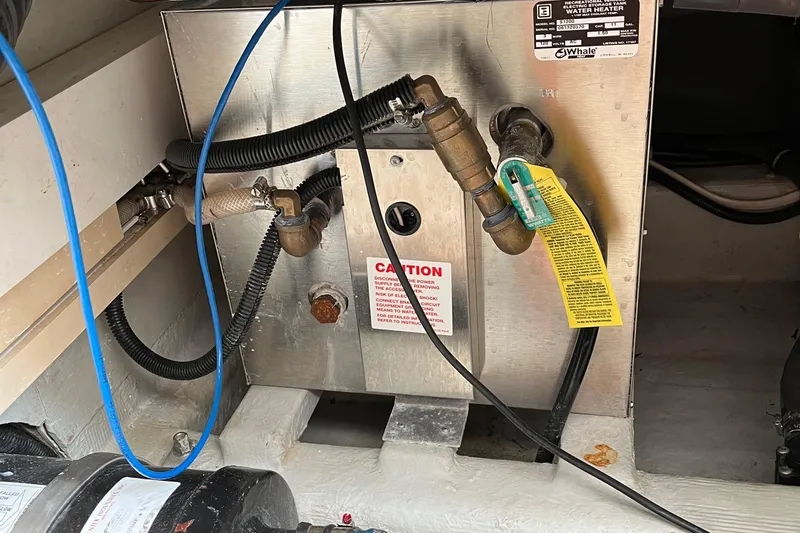 Spirit Yacht Photos Pics Engine room of 2001 Cabo Rico Northeast 400 with water heater and piping.