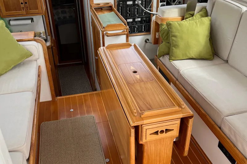 Spirit Yacht Photos Pics Interior of 2001 Cabo Rico Northeast 400 yacht with wooden furnishings and green cushions.