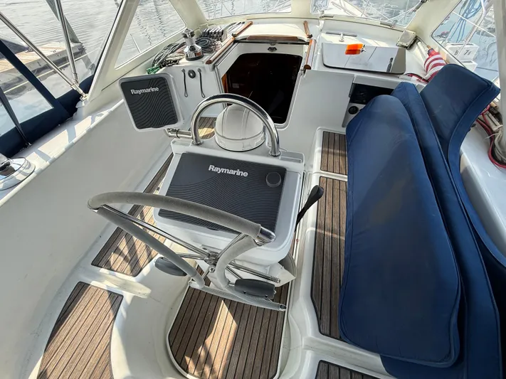 Southern Cross Yacht Photos Pics Cockpit of 2003 Beneteau Oceanis 42CC sailboat with Raymarine equipment and blue seating.