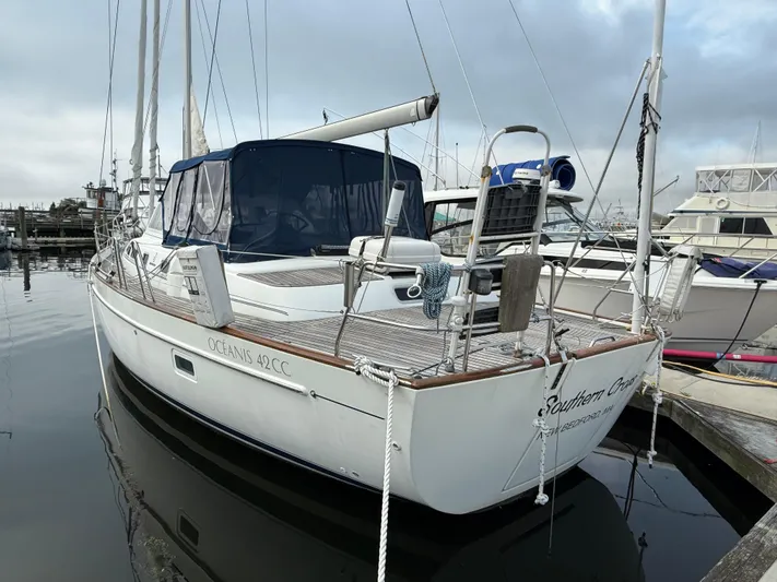 Southern Cross Yacht Photos Pics 2003 Beneteau Oceanis 42CC sailboat docked at marina, overcast sky.