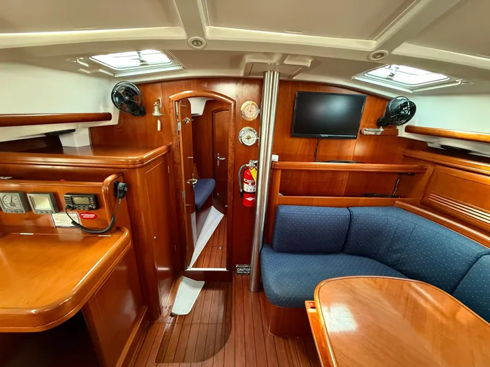 Southern Cross Yacht Photos Pics Interior of 2003 Beneteau Oceanis 42CC yacht with wood finish, seating, and navigation equipment.