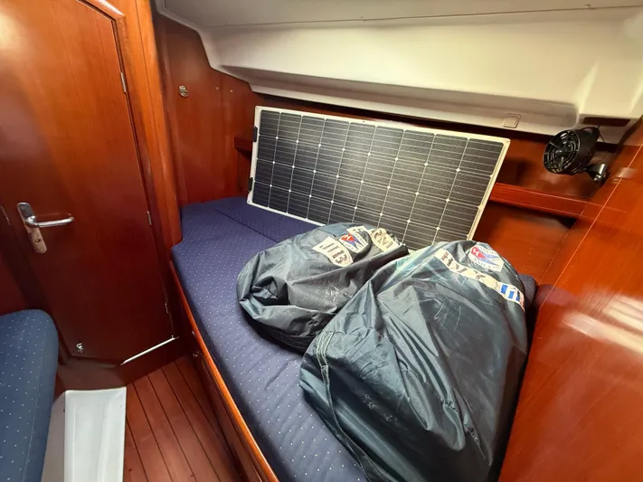 Southern Cross Yacht Photos Pics Interior of 2003 Beneteau Oceanis 42CC with solar panel and bags on bed.