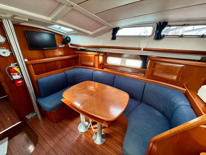 Southern Cross Yacht Photos Pics Interior of 2003 Beneteau Oceanis 42CC yacht with cozy seating and wooden table.