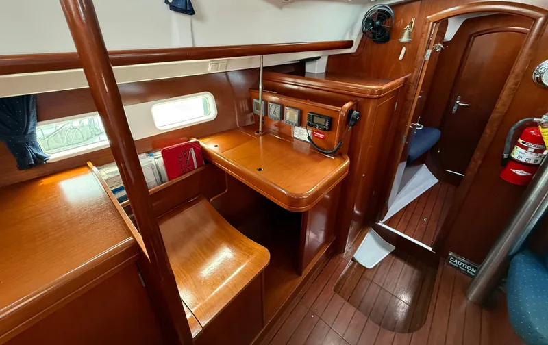 Southern Cross Yacht Photos Pics Interior of 2003 Beneteau Oceanis 42CC sailboat with wooden furnishings and navigation station.