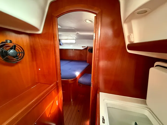 Southern Cross Yacht Photos Pics Interior of 2003 Beneteau Oceanis 42CC sailboat with wood finish and cozy cabin.