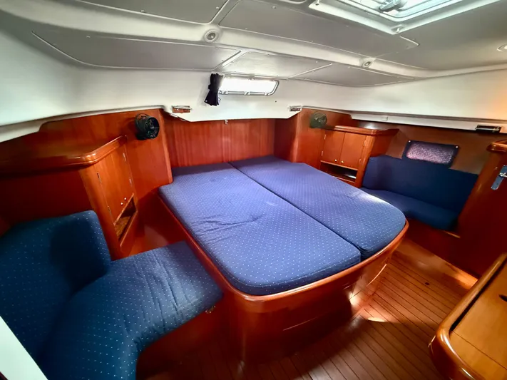 Southern Cross Yacht Photos Pics Interior of 2003 Beneteau Oceanis 42CC yacht with blue upholstery and wooden finish.