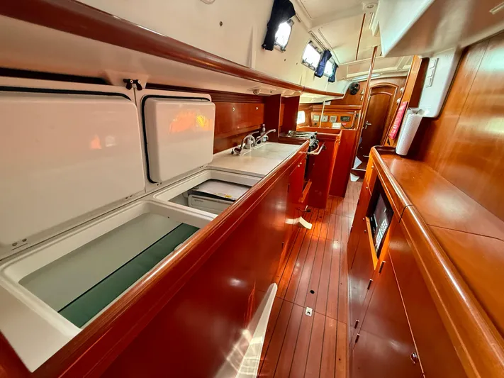 Southern Cross Yacht Photos Pics Interior of 2003 Beneteau Oceanis 42CC yacht, featuring a sleek wooden galley design.