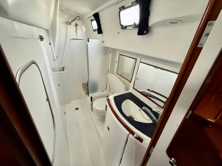 Southern Cross Yacht Photos Pics Bathroom interior of 2003 Beneteau Oceanis 42CC yacht, featuring shower and sink.