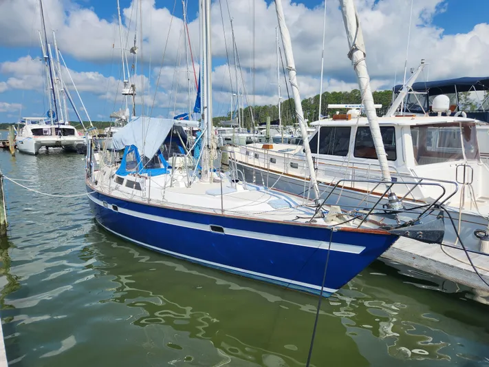 Lea Scotia Yacht Photos Pics 1989 Taswell 43 sailboat docked in a marina under a partly cloudy sky.