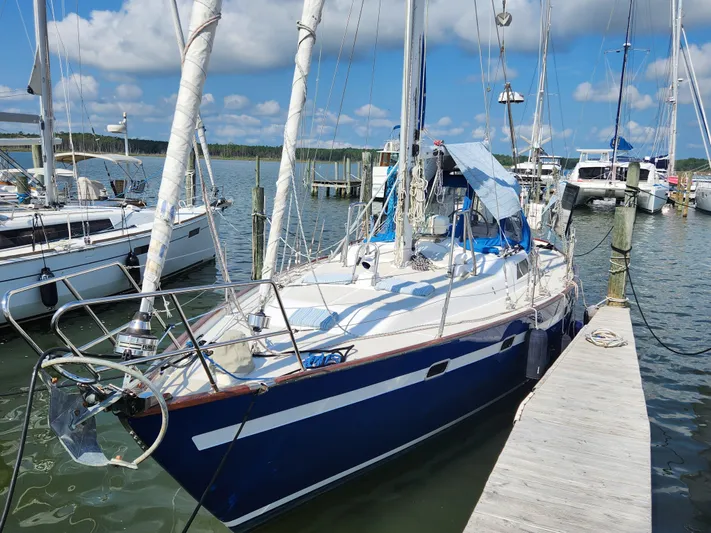 Lea Scotia Yacht Photos Pics 1989 Taswell 43 sailboat docked at a marina under a partly cloudy sky.
