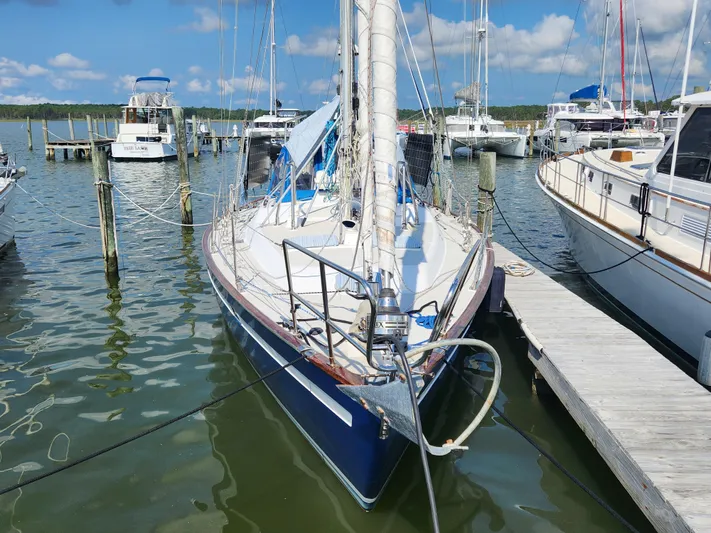 Lea Scotia Yacht Photos Pics 1989 Taswell 43 sailboat docked at marina, surrounded by other boats under a clear blue sky.
