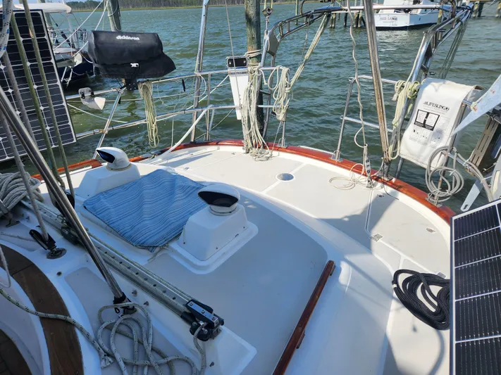 Lea Scotia Yacht Photos Pics 1989 Taswell 43 sailboat deck with ropes, solar panels, and lifebuoy on calm water.