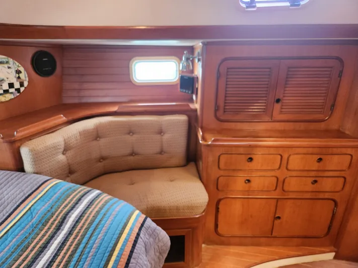 Lea Scotia Yacht Photos Pics Interior of 1989 Taswell 43 yacht with wooden cabinetry and cushioned seating.