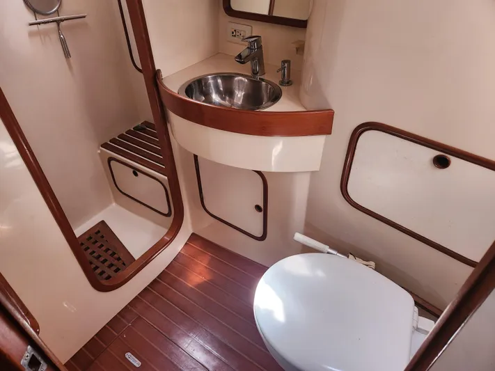Lea Scotia Yacht Photos Pics 1989 Taswell 43 yacht bathroom with sink, toilet, and wooden accents.
