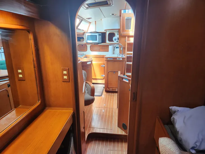 Lea Scotia Yacht Photos Pics Interior of 1989 Taswell 43 sailboat, featuring wooden cabinetry and modern amenities.