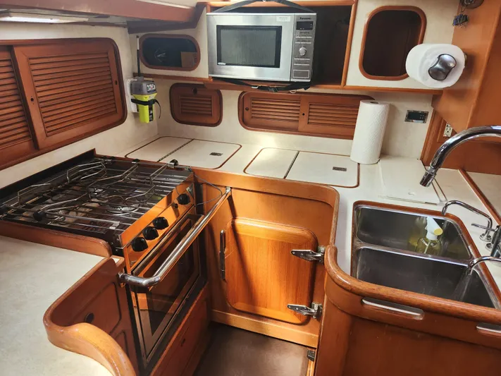 Lea Scotia Yacht Photos Pics 1989 Taswell 43 yacht kitchen with stove, microwave, and sink.