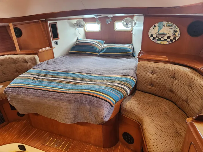 Lea Scotia Yacht Photos Pics Cozy cabin interior of 1989 Taswell 43 yacht with striped bedding and cushioned seating.