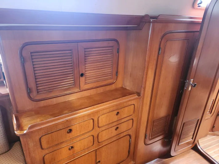 Lea Scotia Yacht Photos Pics Wooden interior cabinetry of a 1989 Taswell 43 yacht, featuring drawers and louvered doors.