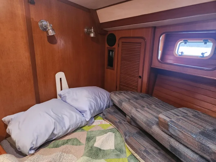 Lea Scotia Yacht Photos Pics Cozy cabin interior of 1989 Taswell 43 sailboat with wooden paneling and bedding.