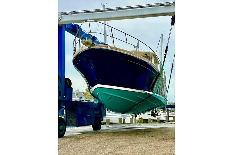 No Rules Yacht Photos Pics 2003 Grand Banks Eastbay 43 HX yacht being lifted at a marina.