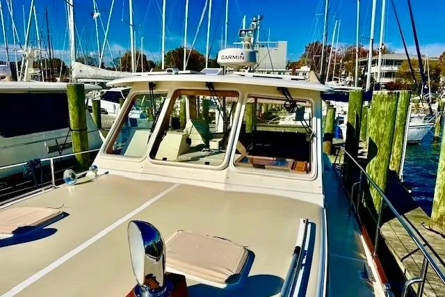 No Rules Yacht Photos Pics 2003 Grand Banks Eastbay 43 HX docked at marina, showcasing sleek design and navigation equipment.