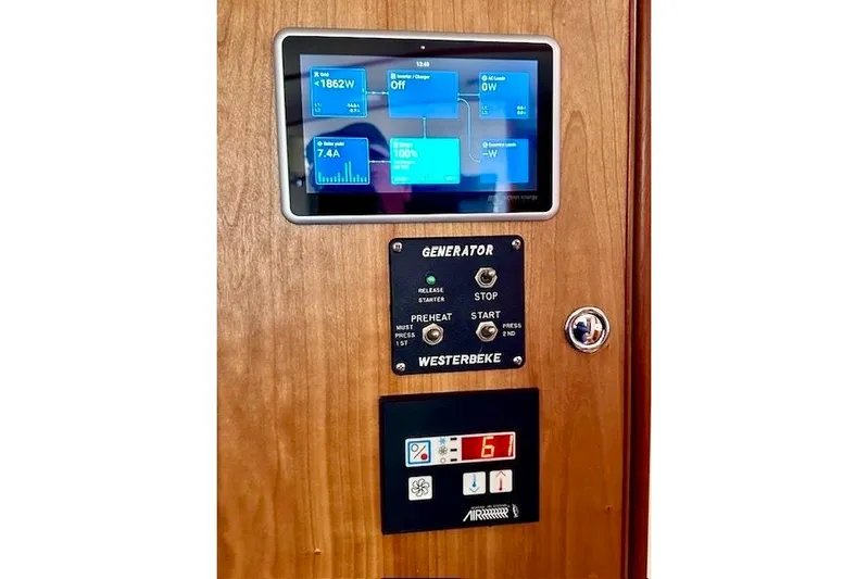 No Rules Yacht Photos Pics Control panel of a 2003 Grand Banks Eastbay 43 HX yacht, featuring generator and display.