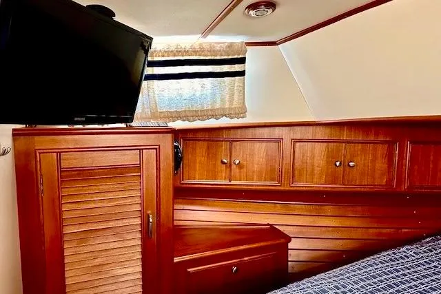 No Rules Yacht Photos Pics Interior of 2003 Grand Banks Eastbay 43 HX with wood cabinetry and mounted TV.