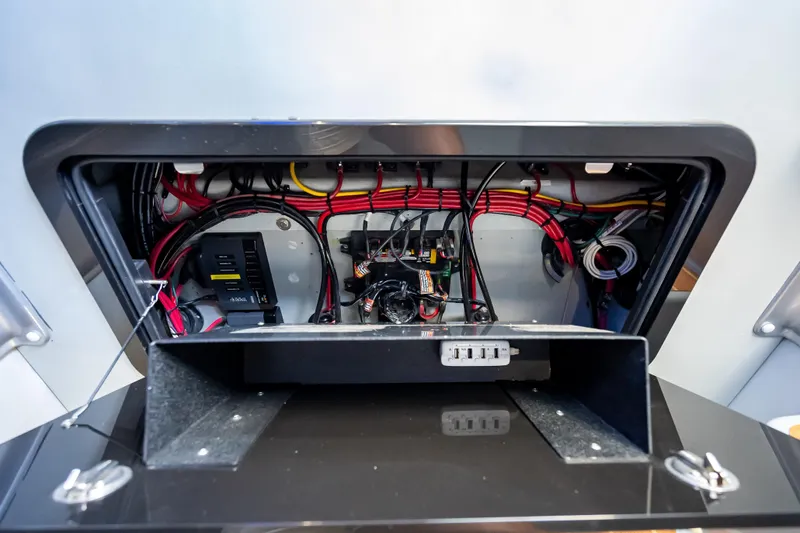  Yacht Photos Pics Electrical wiring compartment of a 2012 Yellowfin 39 boat, showcasing organized cables and components.