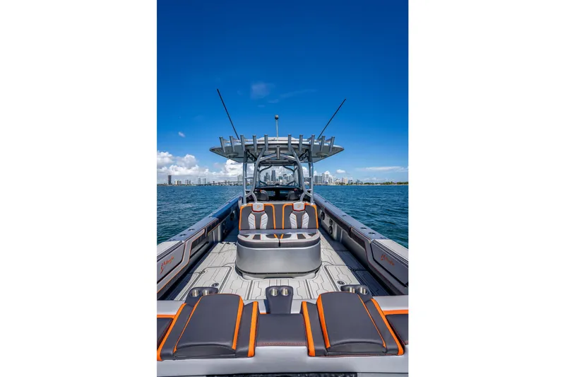  Yacht Photos Pics 2012 Yellowfin 39 boat interior with seating, ocean view, and city skyline in background.