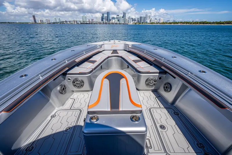  Yacht Photos Pics 2012 Yellowfin 39 boat interior with city skyline in background, featuring sleek seating and speakers.