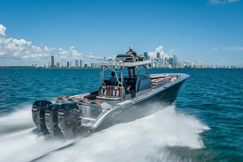 Yacht Photos Pics 2012 Yellowfin 39 boat cruising on water with city skyline in background.