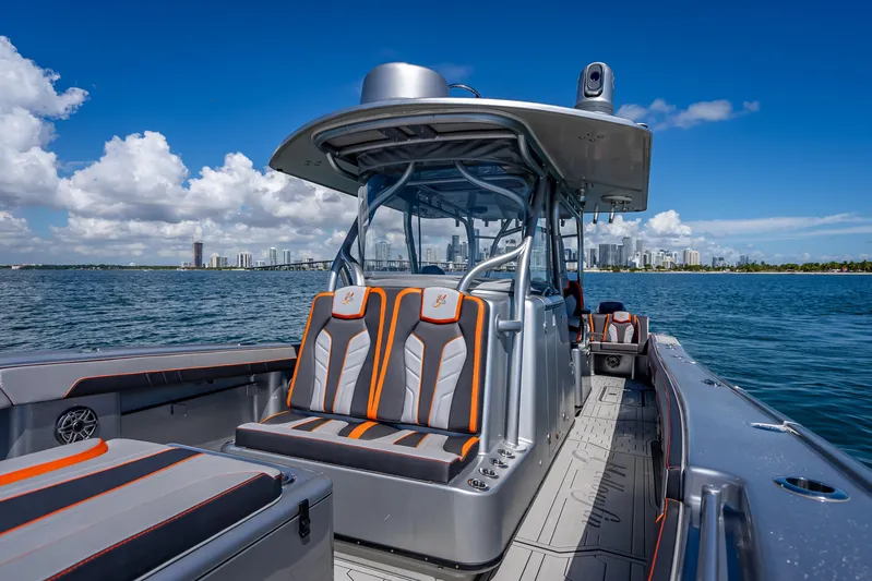 Yacht Photos Pics 2012 Yellowfin 39 boat with sleek seating, cruising on a sunny day near city skyline.