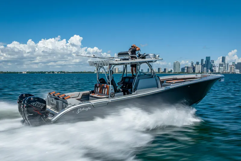  Yacht Photos Pics 2012 Yellowfin 39 boat cruising on water with city skyline in background.