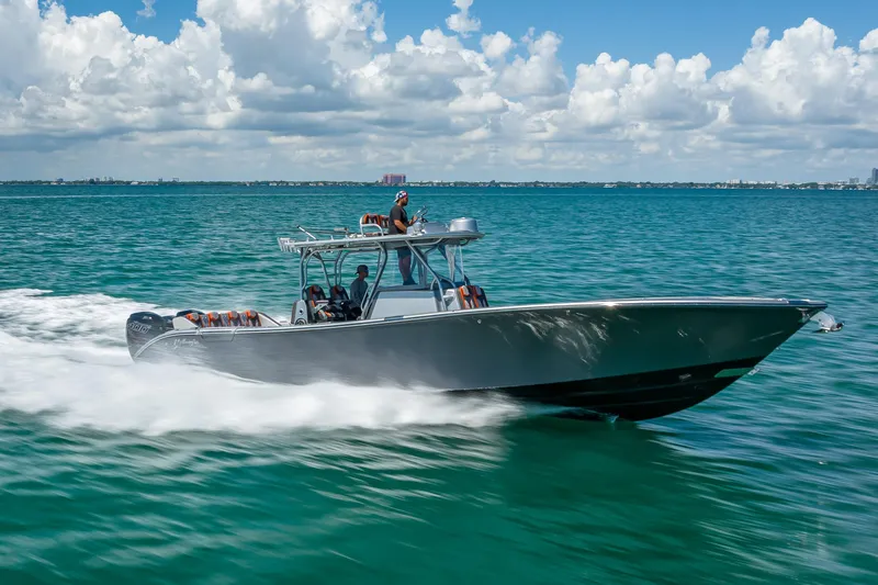  Yacht Photos Pics 2012 Yellowfin 39 boat cruising on clear blue ocean under a partly cloudy sky.