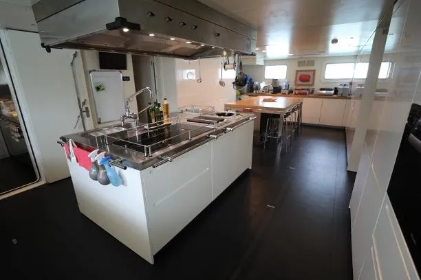 Tribu Yacht Photos Pics Spacious kitchen on 2007 Mondomarine Explorer yacht with modern appliances and central island.