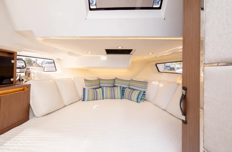 Nauti Brigi Gull Yacht Photos Pics Interior cabin of 2021 Jeanneau Leader 12.5 WA with cozy bedding and cushions.