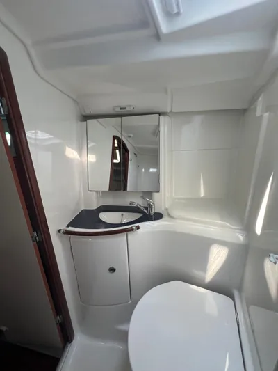 Nemesis Yacht Photos Pics Bathroom interior of 2005 Beneteau Oceanis 473 yacht, featuring sink and mirror.