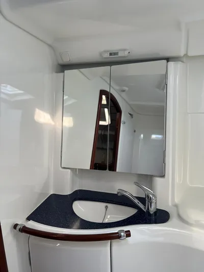 Nemesis Yacht Photos Pics Bathroom interior of 2005 Beneteau Oceanis 473 yacht with mirror and sink.