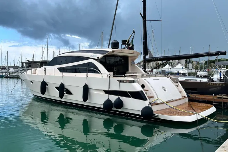  Yacht Photos Pics Luxurious 2011 Cayman Yachts 60 HT moored in a marina under cloudy skies.