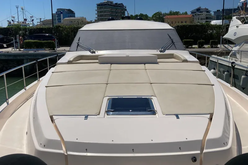  Yacht Photos Pics 2011 Cayman Yachts 60 HT luxury yacht docked, featuring spacious sunbathing area.