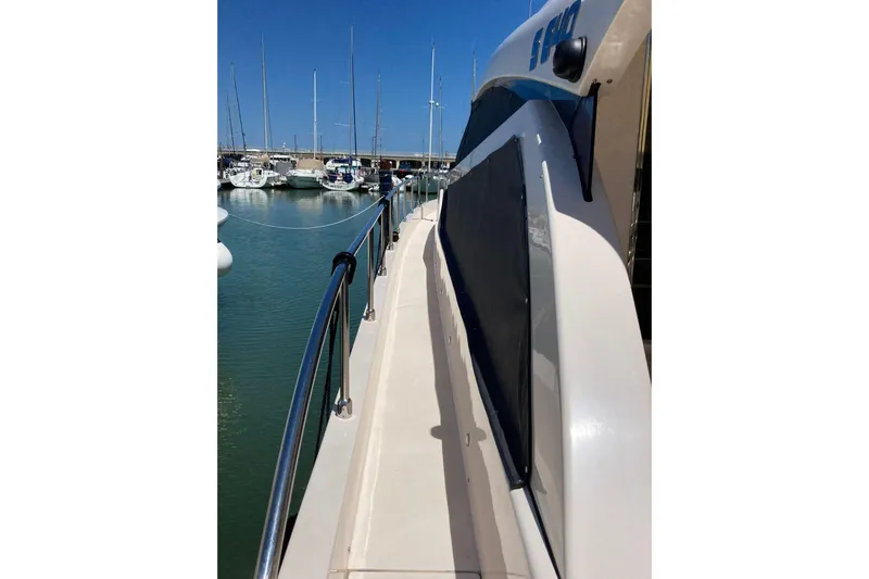  Yacht Photos Pics Side view of 2011 Cayman Yachts 60 HT docked in a marina.