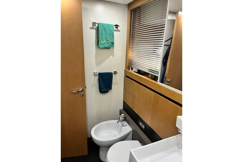 Yacht Photos Pics Bathroom interior of 2011 Cayman Yachts 60 HT with modern fixtures and wooden accents.
