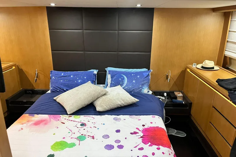  Yacht Photos Pics Luxurious bedroom interior of 2011 Cayman Yachts 60 HT with colorful bedding and wooden accents.
